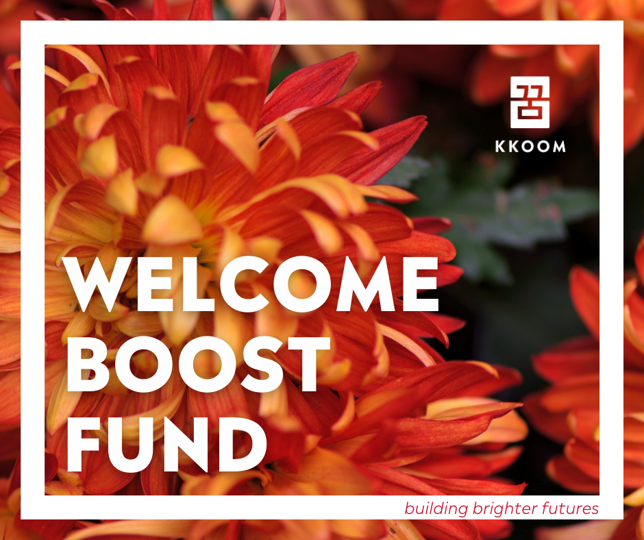 KKOOM Welcome Boost Fund graphic with orange flowers and text ‘building brighter futures.